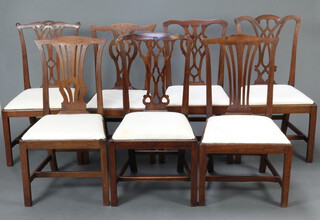 A harlequin set of 7 19th Century Chippendale style slat back dining chairs with upholstered drop in seats, raised on square supports with box frame stretchers 
