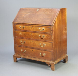 A Georgian oak bureau, the fall front revealing a well fitted interior above 4 long drawers with brass swan neck drop handles, raised on bracket feet 99cm h x 94cm w x 51cm d 