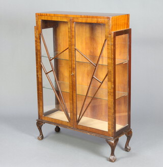 A 1930's Art Deco mahogany display cabinet, fitted glazed shelves, enclosed by an astragal sunburst glazed door, raised on cabriole supports 126cm h x 88cm w x 30cm d 
