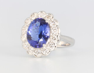 An 18ct white gold oval tanzanite and diamond cluster ring, the centre stone approx. 4.55ct, the diamonds approx. 1.3ct, 7.6 grams, size N    
