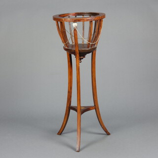 A circular Edwardian inlaid mahogany jardiniere stand raised on outswept supports with shaped undertier 91cm h x 36cm diam. (metal jardiniere is missing) 