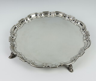 A Georgian style silver salver with Chippendale border raised on scroll feet Sheffield 1968, 30cm, 196 grams 