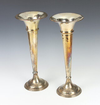 A pair of silver plated tapered posy vases 38cm 