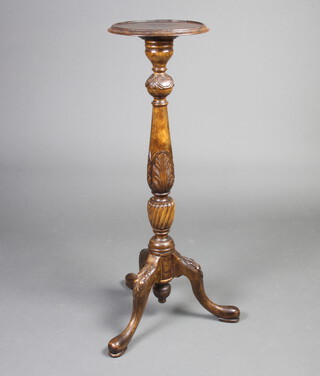 An Edwardian turned and carved beech jardiniere stand raised on a pillar and tripod base 105cm h x 33cm 
