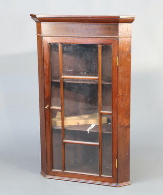 A 19th/20th Century mahogany hanging corner cabinet with moulded cornice, fitted shelves enclosed by astragal glazed panelled doors 101cm h x 64cm w x 45cm d Â§