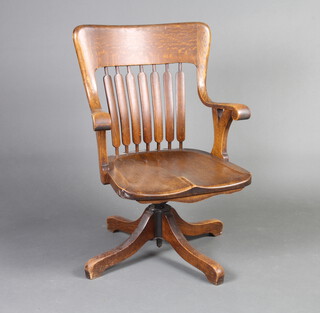 An Edwardian oak, stick and bar back revolving office chair 91cm h x 61cm w x 48cm d (seat 37cm x 35cm)  