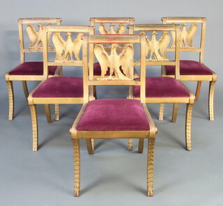 A set of 6 Empire style gilt painted bar back dining chairs with carved eagle splat backs and upholstered seats, raised on sabre supports 87cm h x 47cm w x 45cm d (seat 34cm x 36cm)  