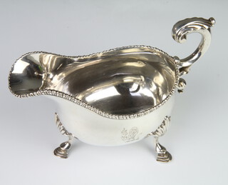 A George III silver sauce boat with gadrooned rim and S scroll handle, raised on hoof feet, London 1771, 388 grams 
