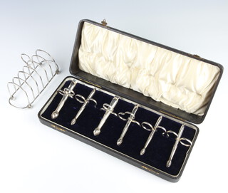 A cased set of 6 silver plated asparagus tongs together with a ditto 6 bar toast rack 