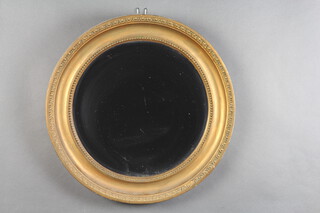 A circular bevelled plate wall mirror contained in a decorative gilt frame 47cm 