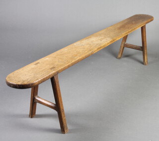 A 19th Century oval oak bench raised on outswept supports 43cm h x 188cm w x 20cm d 