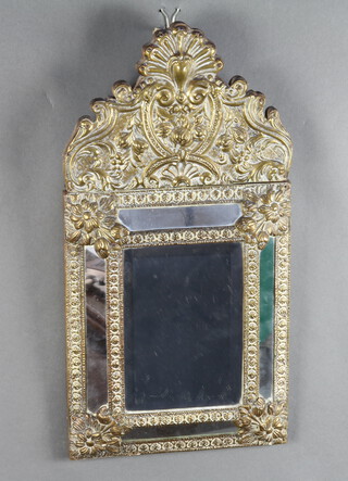 A 19th Century Continental bevelled plate mirror contained in a rectangular embossed brass frame 53cm h x 27cm w 
