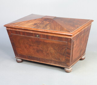 A 19th Century mahogany cellarette of sarcophagus form with hinged lid, raised on bun supports with later zinc liner 43cm h x 80cm w x 54cm d 