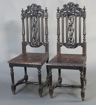 A pair of Victorian ebonised pierced and carved hall chairs with solid seats, raised on turned and block supports with H framed stretcher 44cm h x 45cm w x 41cm d 