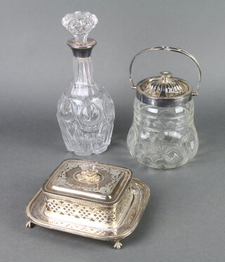 An Edwardian silver plated sardine dish, a biscuit barrel and a decanter 