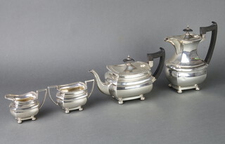 An Art Deco silver 4 piece tea and coffee set comprising teapot, coffee pot, cream jug and sugar bowl with gadrooned rims and ball feet, Sheffield 1932, gross 1416 grams