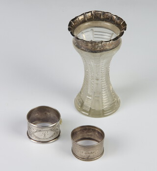 Two silver  napkin rings, marks rubbed, 34 grams and a silver mounted cut glass vase 44 grams weighable silver 