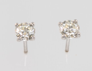 A pair of 18ct white gold claw set, brilliant cut diamond ear studs 1.04ct, 2.1 grams