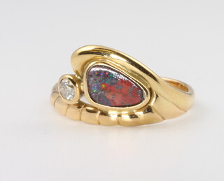 An 18ct yellow gold opal and diamond ring, the diamond 0.10ct, the opal 8mm x 5mm, 3.5 grams, size M  
