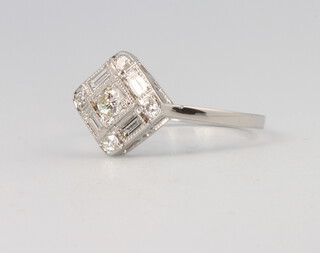 A platinum Art Deco style brilliant and baguette cut diamond ring 0.5ct, 3.4 grams, size N 1/2