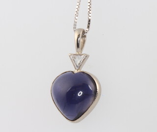 An 18ct white gold Iolite heart shaped pendant set with a triangular cut diamond 0.4ct, the Iolite measures 15mm x 15mm, the chain is 3.9 grams, 50mm long 