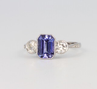 A platinum 3 stone diamond and tanzanite ring, the emerald cut tanzanite 1.7ct, the 2 brilliant cut diamonds 0.65ct, 4.2 grams, size O 