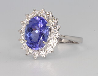 An 18ct white gold oval tanzanite and diamond cluster ring, the centre stone 2.45ct, the brilliant cut diamonds 0.65ct, 2.8 grams, size K 1/2
