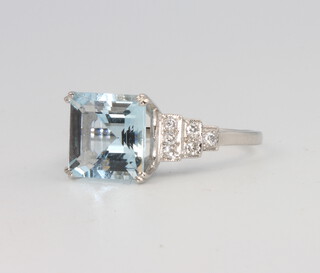 An Art Deco style platinum square cut aquamarine and diamond cocktail ring, the centre stone 2.8ct, the brilliant cut diamonds 0.2ct, 5.2 grams, size N 1/2 