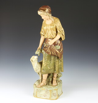 A Royal Dux figure of a standing Shepherdess standing beside a sheep, raised on a floral base 78cm h 