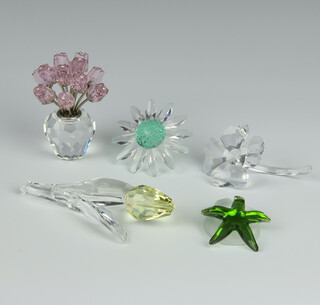 A Swarovski Crystal vase of flowers 7cm, 2 petals 4cm, a tulip 8cm and a starfish 2cm, boxed 