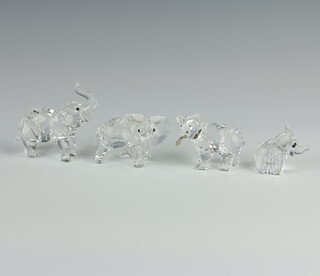 A Swarovski Crystal figure of an elephant with trunk raised 7cm, ditto 4cm, bird with fish in mouth 4cm and a baby elephant 3cm boxed