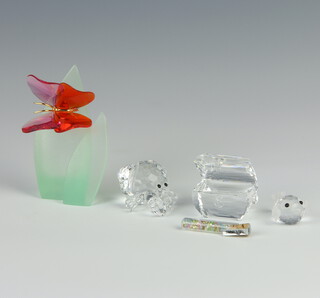 A Swarovski Crystal figure of a red glass butterfly on leaves 9cm, a hermit crab 3cm, treasure chest 5cm and a baby puffer fish 2cm, boxed