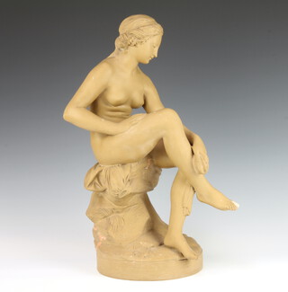 In the manner of James Pradier, a ceramic figure of a seated naked lady raised on a circular base, matt finish, 47cm 