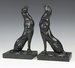 A pair of Art Deco style black glazed figures of seated big cats, raised on plinth base 31cm 