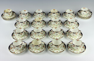 A Crescent China tea set comprising 19 cups (2 a/f) and 24 saucers decorated with roses 