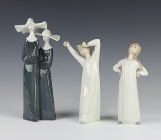 A Lladro figure - The Girl in a nightdress 20cm, ditto of a boy yawning 22cm together with a Continental group of 2 nuns 24cm 