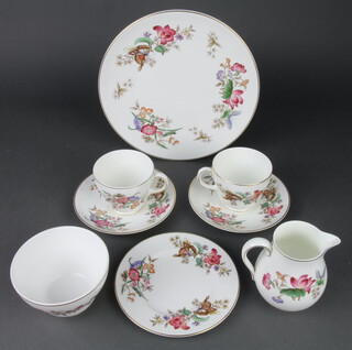 A Wedgwood Sandon pattern part tea service comprising 6 tea cups, 5 saucers, 6 sandwich plates, a milk jug, sugar bowl, cake plate