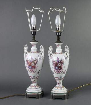 A pair of table lamps in the style of Chinese export twin handled urns with armorial decoration 37cm h x 10cm w x 11cm d  