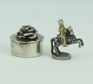 A silver trinket box with rose lid 2.5cm together with a white metal figure of a gentleman on horseback 30.4 grams