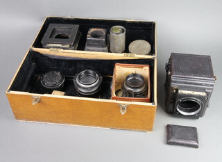 A Popular Pressman Camera, the lens marked 14 IN F/5.6 UU282547, a lens marked 2.9 4 5.6 8 11 16 22, a Plaubel & Co Frankfurt a M81791 lens together with 2 Air Ministry lenses marked NOC Pentac 8 inch/2.9 017747 and 14A/2445, all contained in an oak box 