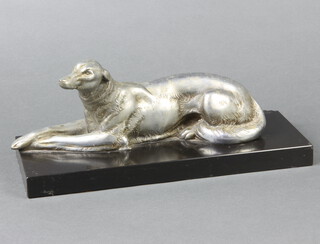 An Art Deco French spelter figure of a reclining Afghan hound raised on a black marble base 13cm h x 32cm w x 12cm d 