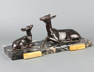 An Art Deco spelter figure group of a seated deer and faun, raised on a 2 colour marble base 16cm h x 41cm w x 18cm d 