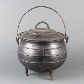A circular iron cauldron with swing handle and lid 23cm h x 26cm diam. 