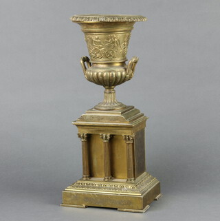 A Victorian gilt metal urn of campanula form raised on a rectangular base supported by columns 36cm h x 16cm w x 12cm d 