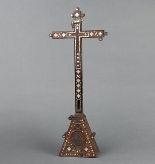 A 19th Century inlaid olive wood and mother of pearl cross, raised on a triangular shaped base 46cm h x 12cm w x 7cm d 