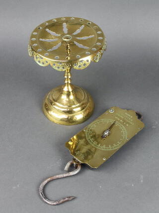A Victorian Salters Class III brass spring balance 36lbs x 1/4lbs together with a circular pierced brass stand raised on a waisted foot 24cm x 18cm  