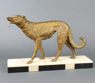 An Art Deco gilt painted spelter figure of a standing Afghan hound, raised on  a 2 colour marble base 18cm h x 45cm w x 11cm d 