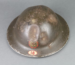 A Second World War National Fire Service steel helmet complete with liner, the interior marked Roco 1 1939, with National Fire Service badge, marked 18, with numerous dents 