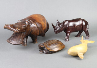 An African carved hardwood figure of a hippopotamus 15cm x 34cm x 14cm, ditto rhino 13cm x 27cm x 7cm, a trinket box in the form of a turtle 3cm x 12cm x 7cm and a carved wooden figure of a whale 9cm h 
 