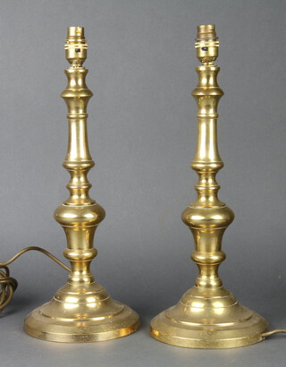 A pair of brass table lamps in the form of candlesticks 38cm h x 17cm 